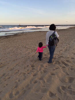 Marjorie Wingert and daughter walking on the beach